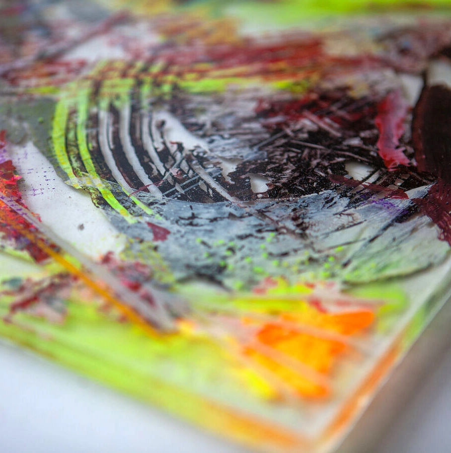 Resin sculpture by Marina Aristotel, titled "Solar life", featuring glass-like layers and organic depth. Hand poured pigments in neon yellow, orange and burgundy creating a luminous, tactile surface. Luxury wall-mounted art object for modern interior design and boutique hotel decor. side detail